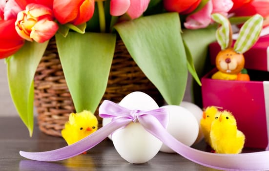 pink present with ribbon and colorful tulips festive easter decoration
