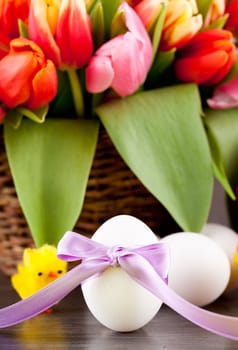 pink present with ribbon and colorful tulips festive easter decoration