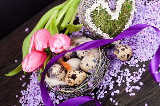 pink tulips and brown eggs with purple ribbon colorful easter decoration