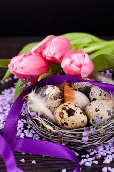pink tulips and brown eggs with purple ribbon colorful easter decoration