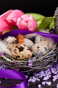 pink tulips and brown eggs with purple ribbon colorful easter decoration