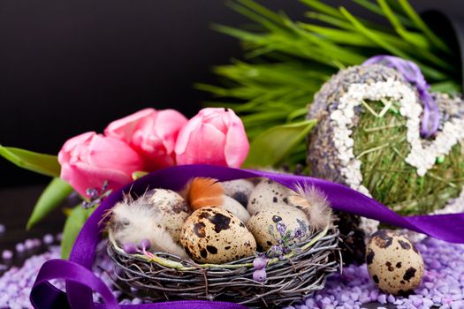 pink tulips and brown eggs with purple ribbon colorful easter decoration