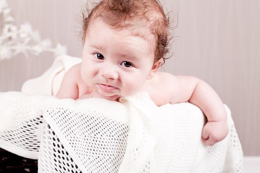 sweet little baby infant toddler on white  blanket in basket at home