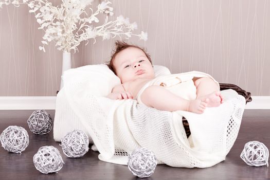 sweet little baby infant toddler on white  blanket in basket at home