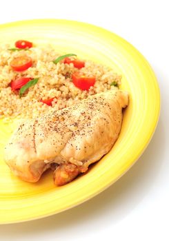 A healthy meal that consists roasted chicken paired with quinoa, tomatoes and basil