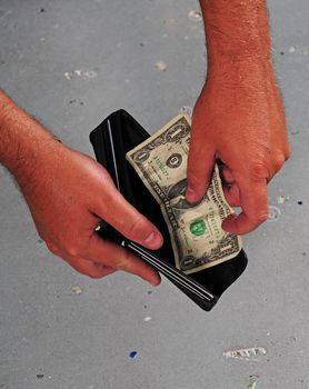 Man spending last dollar while being left with an empty wallet