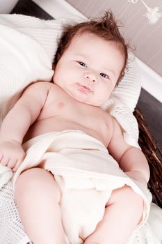 sweet little baby infant toddler on white  blanket in basket at home
