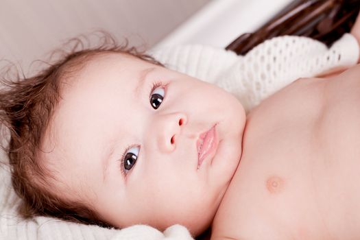 sweet little baby infant toddler on white  blanket in basket at home