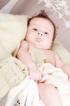 sweet little baby infant toddler on white  blanket in basket at home