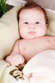 sweet little baby infant toddler on white  blanket in basket at home
