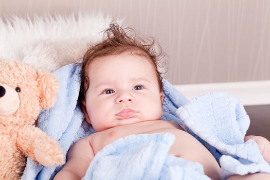 cute little baby todler infant lying on blanket with teddy bear 