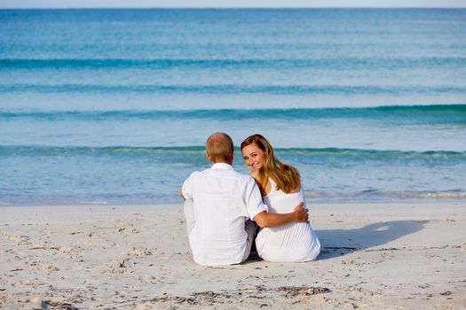 happy young couple in love having fun on the beach blue sky and sunshine 