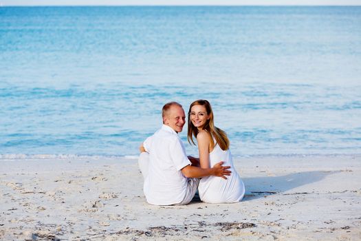 happy young couple in love having fun on the beach blue sky and sunshine 