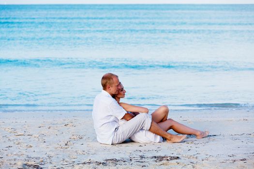 happy young couple in love having fun on the beach blue sky and sunshine 