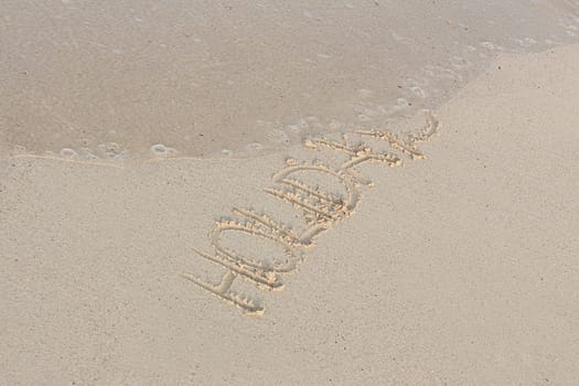 hand writing in sand in summer holiday vacation on beach 