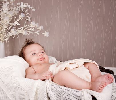 sweet little baby infant toddler on white  blanket in basket at home