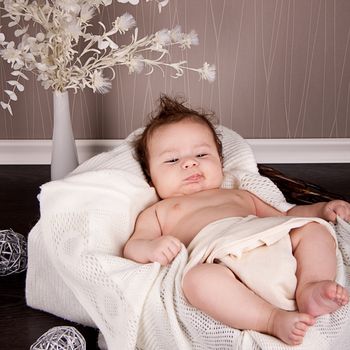 sweet little baby infant toddler on white  blanket in basket at home