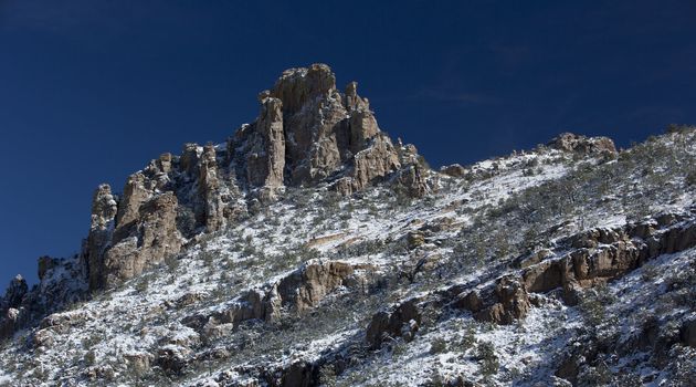 Catalina Mountains slope dusted with snow, viewed from a Mount Lemmon vista, high above the Sonoran desert of Tucson, Arizona in the USA;