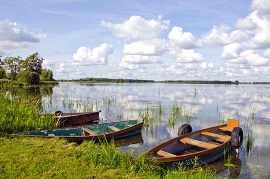 landscape with summer time boats on lake