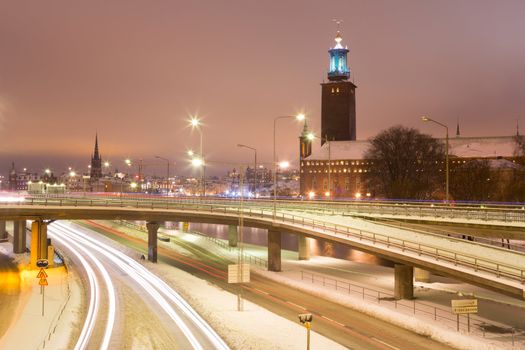 Stockholm Cityhall at night with transportation light trail Sweden