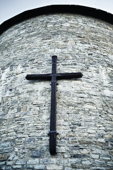 old wooden cross on tower wall, low angle view
