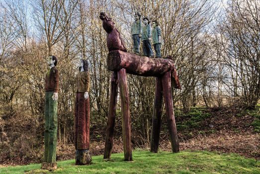 Carved wooden horse and people situated by the side of a main road in Ashford Kent