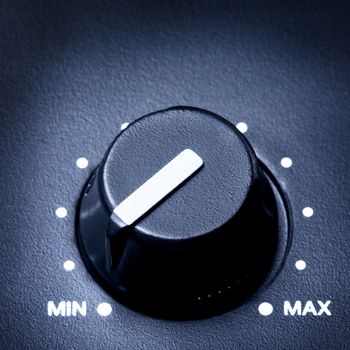 black olume knob on minimum, close up