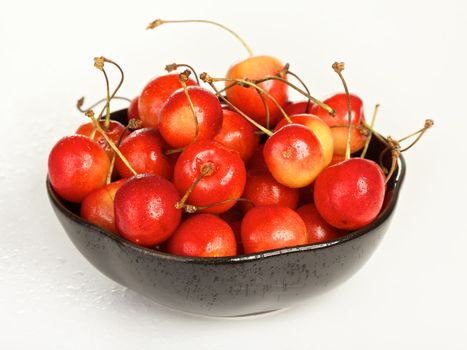 bowl full of cherries isolated on white background