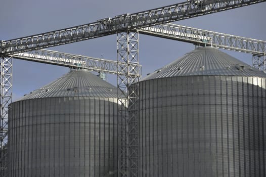 A row of shiny, steel silos