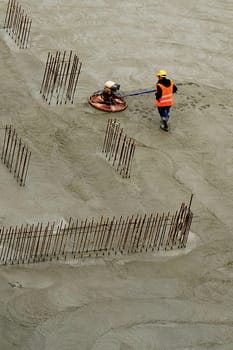 Construction worker on new cement for polishing surface