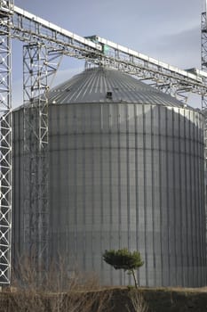 A row of shiny, steel silos