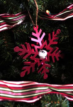 Red Christmas snowflake decoration on Christmas tree