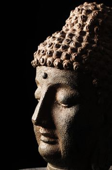 Buddha head isolated on black background