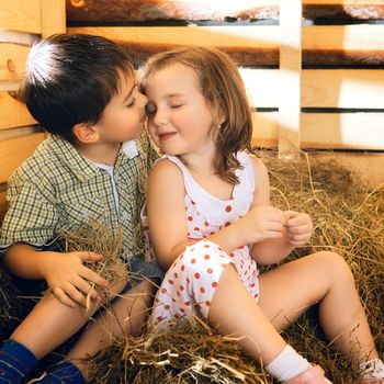 beautiful children on hayloft at sunny day