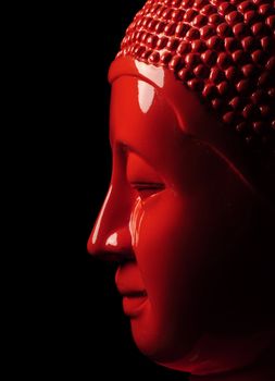 Orange buddha head on black background