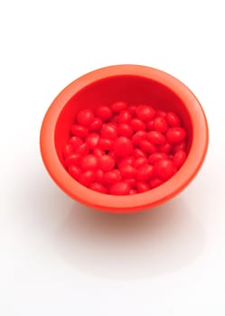 red hots candy in a bowl isolated on a white background