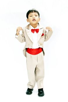Little boy with brown tuxedo and red bow tie on white background