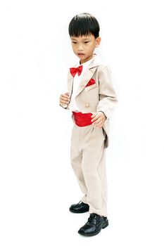 Little boy with brown tuxedo and red bow tie on white background