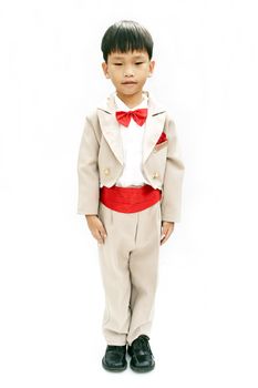 Little boy with brown tuxedo and red bow tie on white background