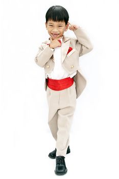 Little boy with brown tuxedo and red bow tie on white background