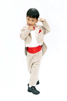 Little boy with brown tuxedo and red bow tie on white background