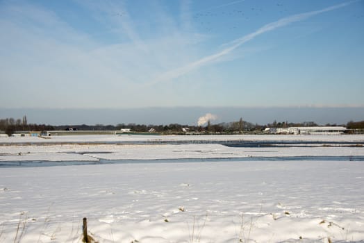 snow in winter landscape with birds and water