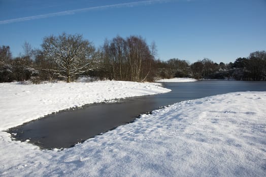 ice on the water in winter landscape with white snow