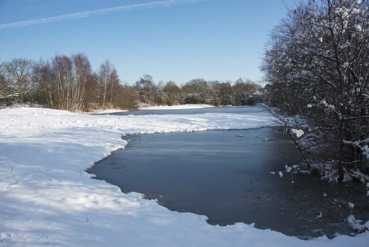 ice on the water in winter landscape with white snow