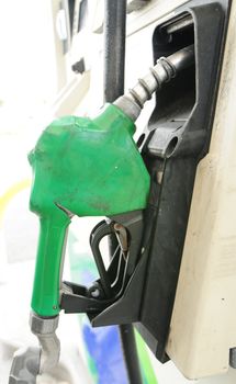 Close up of a green gas pump for refueling at gas station