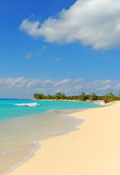 Tropical beach in the Bahamas with white sand and turquoise blue ocean water and nobody on the beach