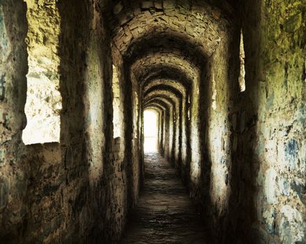 long stone corridor with windows in ancient castle
