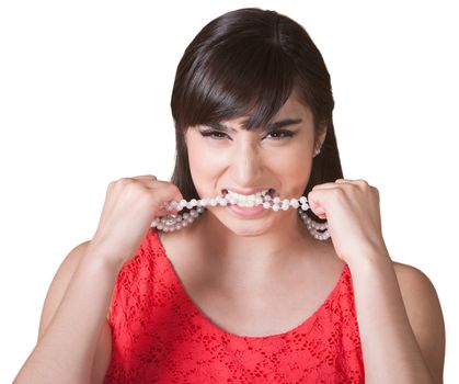 Frustrated woman with pearl necklace in mouth