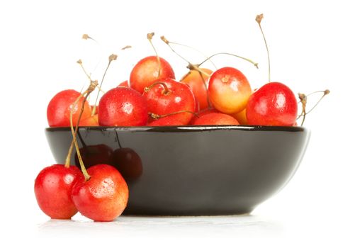 bowl full of cherries isolated on white background