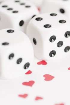 Macro image of dice on love heart background.